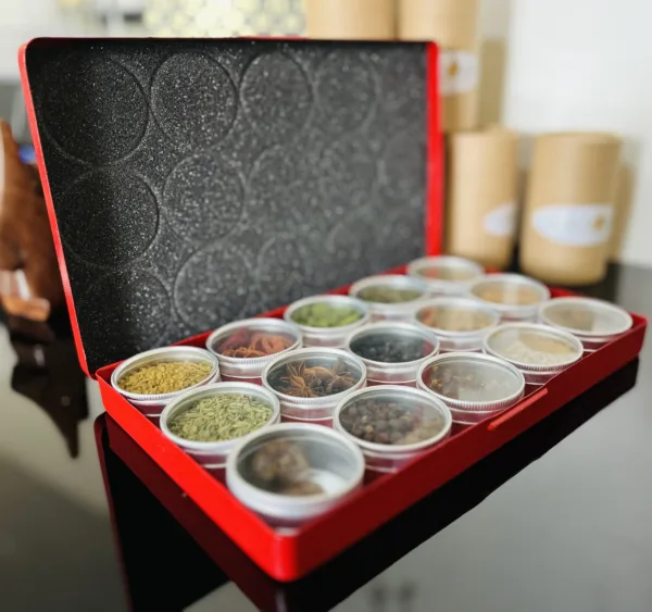 a red box containing 15 different spices stored in separate containers