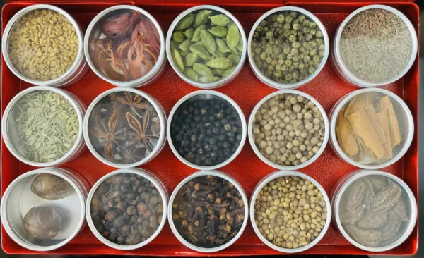 a red box containing 15 different spices stored in separate containers