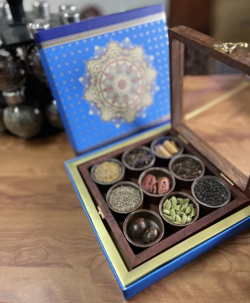 a box containing 9 different spices stored in small containers