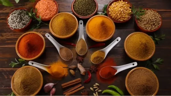 variety of colorful spices and herbs on a wooden surface