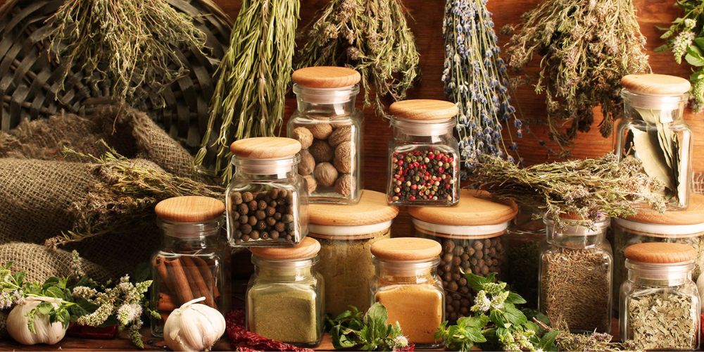 different herbs,whole spices in jar, spice powders stacked together